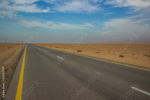 picturesque scenery desert landscape with yellow sand wilderness environment and asphalt empty highway car road, infrastructure and transportation concept photography, copy space