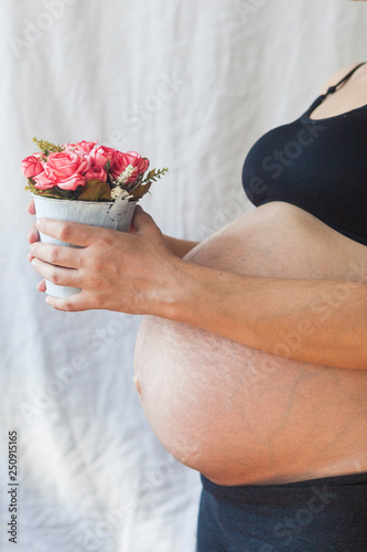 Pregnant woman holding flower pot