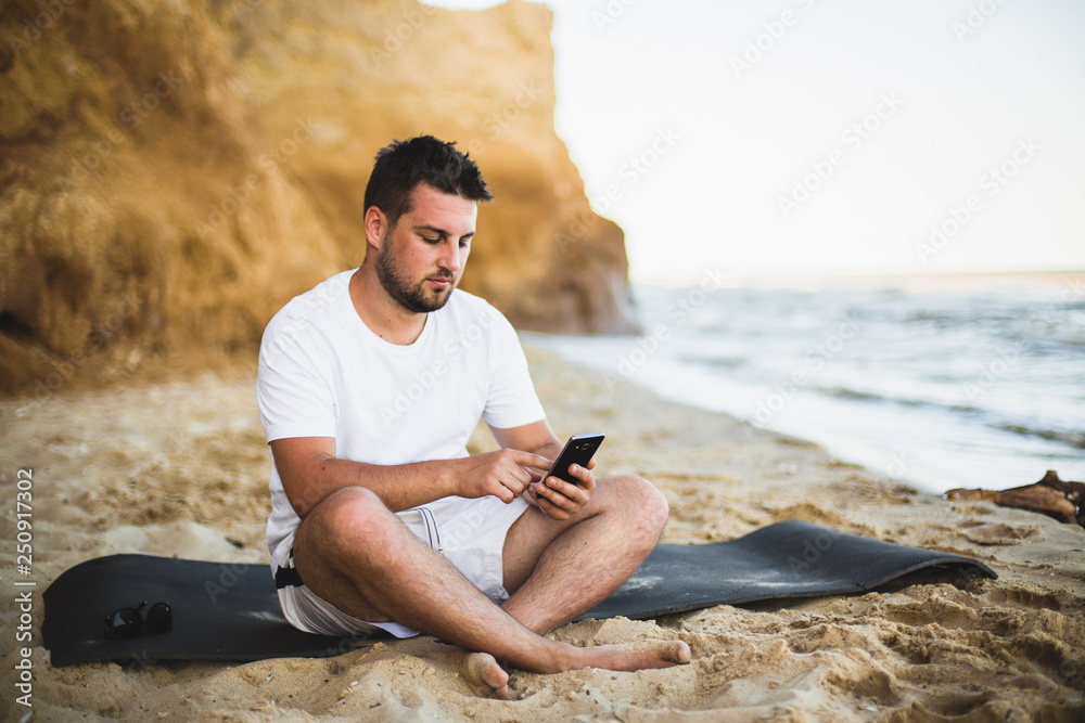 young woman talking with mobile phone on the beach