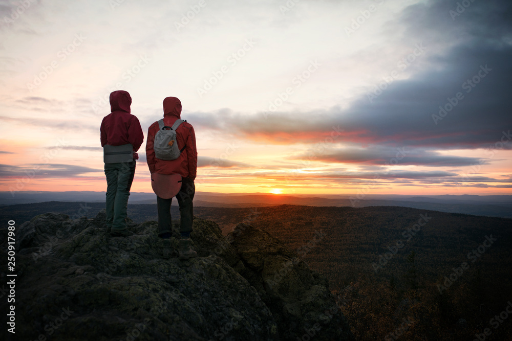 Silhouette of couple looking at sunset Silhouette of couple looking at sunset