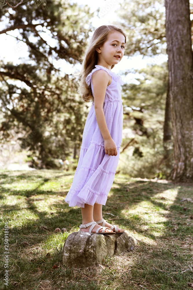 Girl standing on rock in forest Girl standing on rock in forest