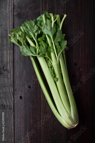 raw whole celery on rustic wood with natural light
