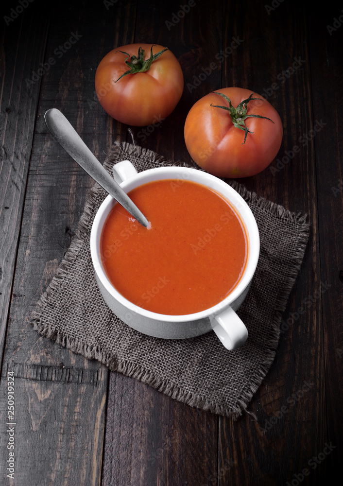 bowl of tomato sauce with tomatoes on rustic wood with natural light bowl of tomato sauce with tomatoes on rustic wood with natural light