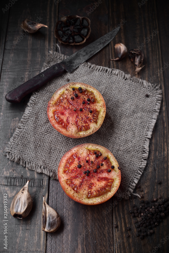 split tomatoes on rustic wood with natural light split tomatoes on rustic wood with natural light