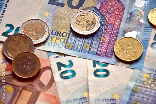 Money euro coins and banknotes on the table. photo