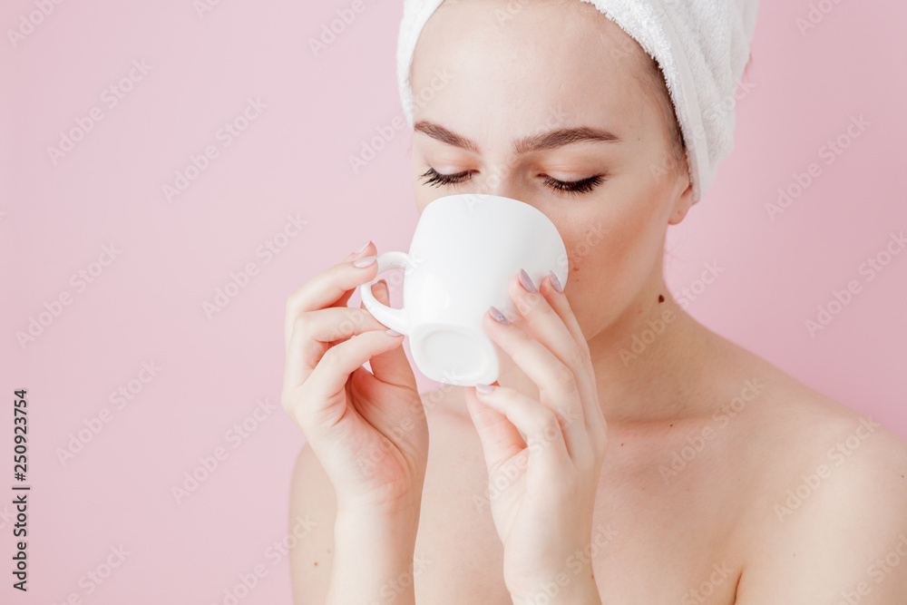 Portrait of beautiful girl in bathrobe with a cup of tea, relaxation concept blonde woman wearing bathrobe and towel on head after shower. Spa woman in bathrobe and turban Portrait of beautiful girl in bathrobe with a cup of tea, relaxation concept blonde woman wearing bathrobe and towel on head after shower. Spa woman in bathrobe and turban