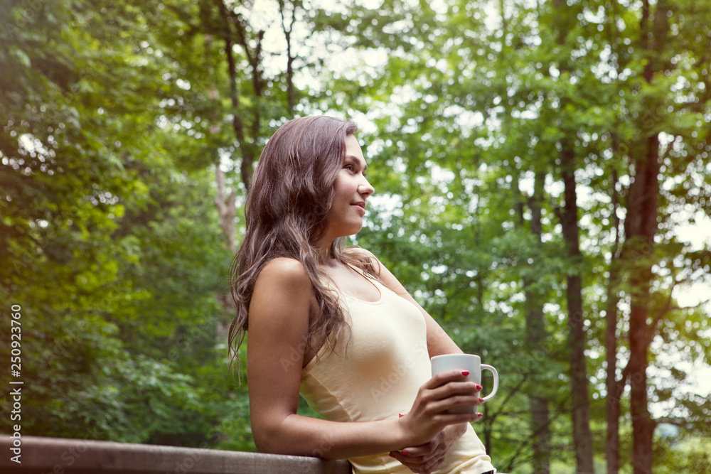 Beautiful young woman on balcony Beautiful young woman on balcony