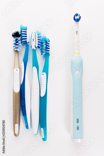 Manual Regular Toothbrush Against Modern Electric Toothbrush. Isolated on White Background