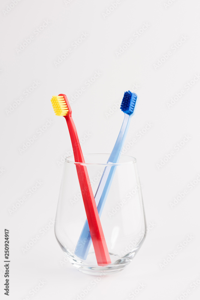 Cup with toothbrushes on table isolated on white background. Dental care Cup with toothbrushes on table isolated on white background. Dental care