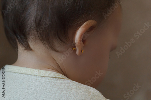 Foto ear piercing for small children, one year old child