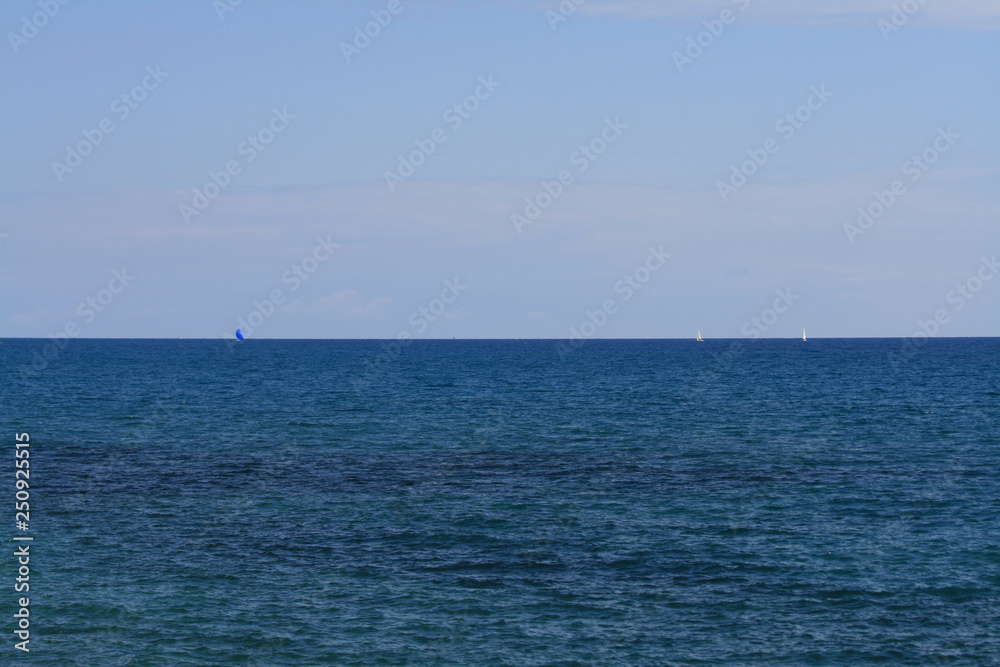 Blue sky and sea with sails 