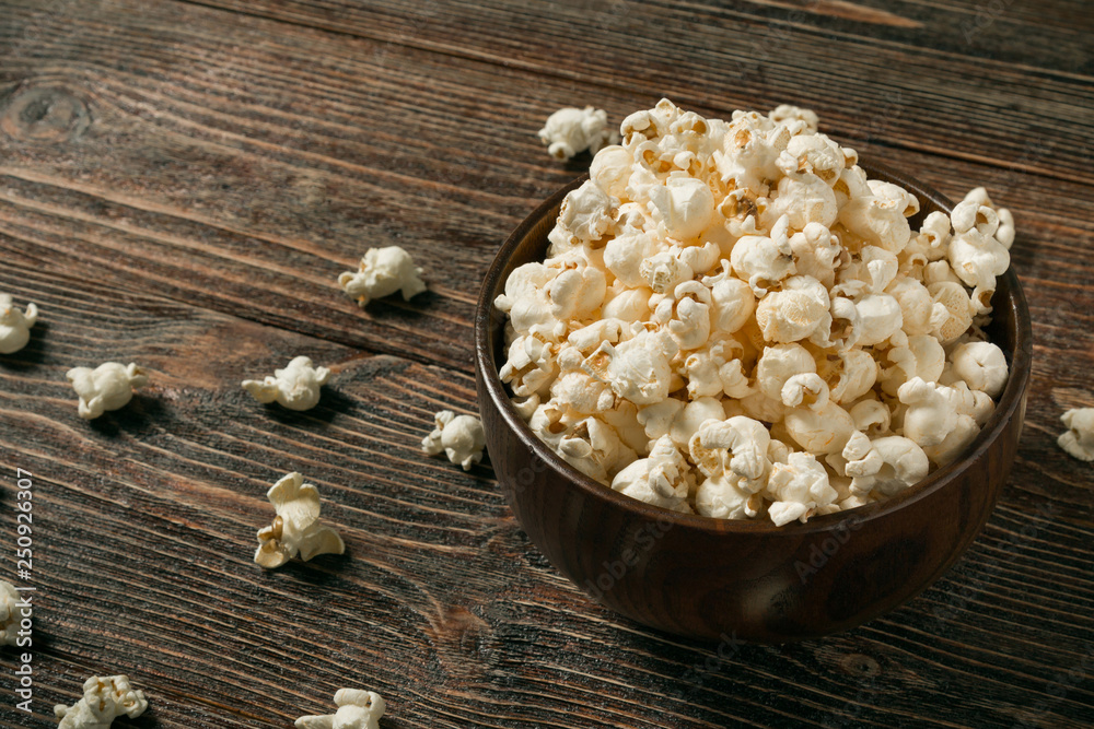 Popcorn in bowl on old wooden background. Popcorn in bowl on old wooden background.