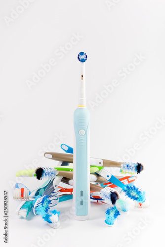 Manual regular Toothbrush Against Modern Electric Toothbrush. Isolated on White Background. Manual used tuthbrushes background