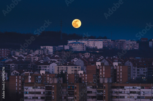 Full moon rising over the city