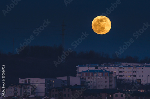 Full moon rising over the city