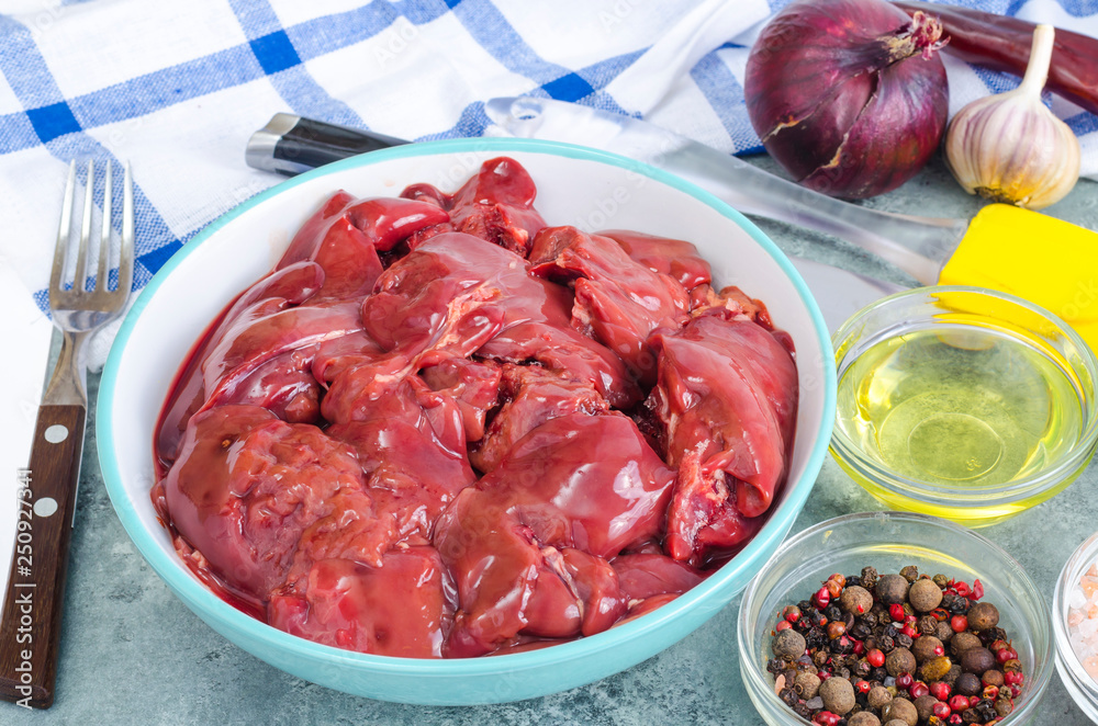 Raw chicken liver for cooking, spices, oil.