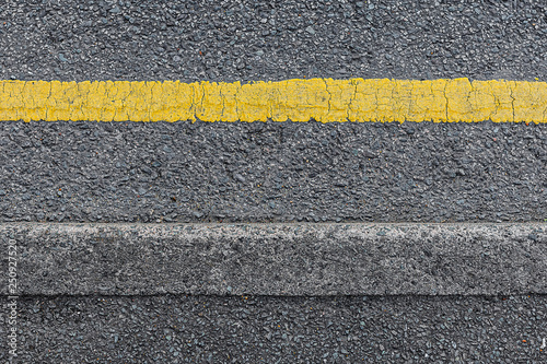 Seamless roadside curb with a single yellow line from above. photo