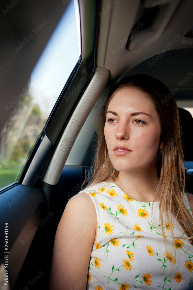 Young woman staring out car window Young woman staring out car window