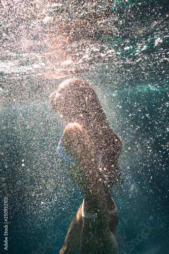 Young women diving underwater  photo