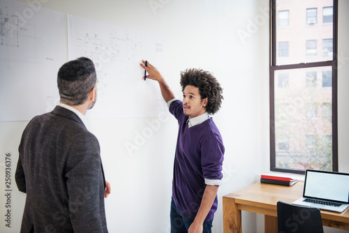 Two men discussing plans in office  photo