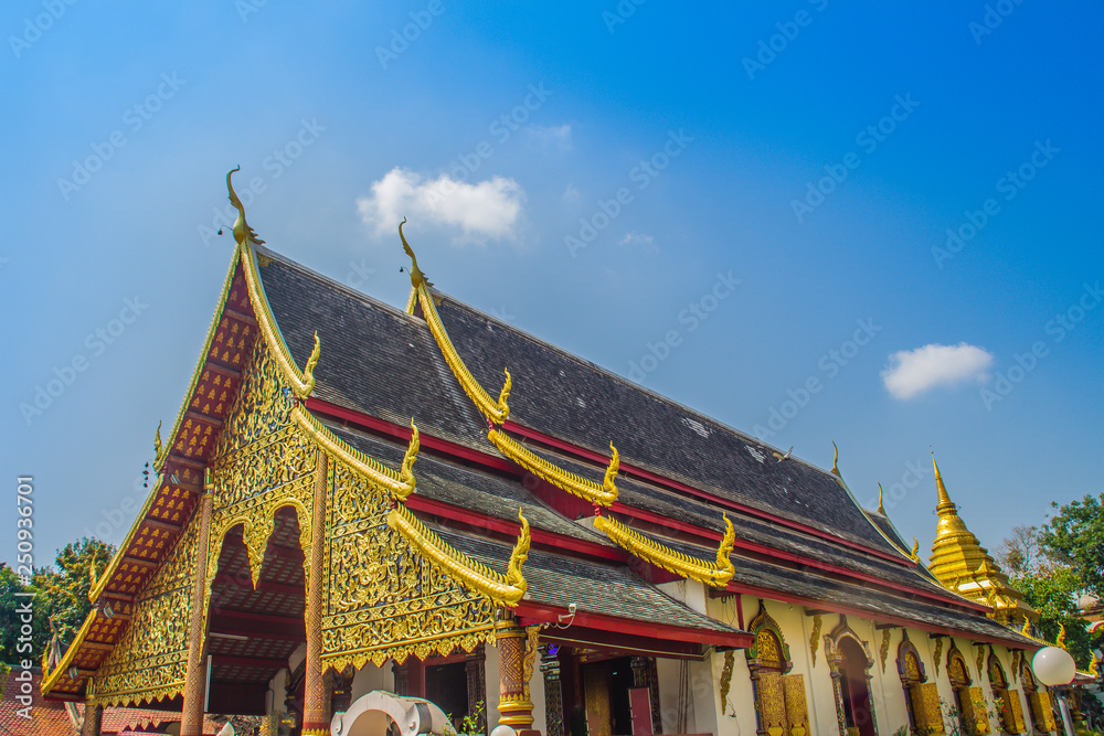Naklejka premium Beautiful golden buddhist church in Lanna-style ordination hall enshrines at Wat Chiang Man or Wat Chiang Mun, the oldest temple in Chiang Mai, Thailand, built in 1296 by King Mengrai in Lanna-style.