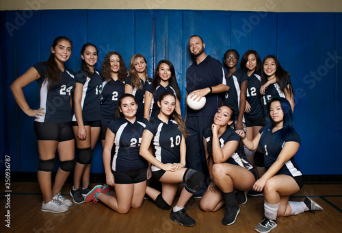 Portrait of teenage girl with volleyball coach  photo