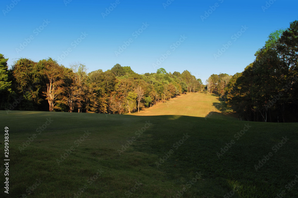 The evening golf course has sunlight shining down at golf course in Thailand The evening golf course has sunlight shining down at golf course in Thailand
