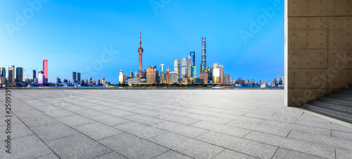 Empty square floor with panoramic city skyline in shanghai at night,China