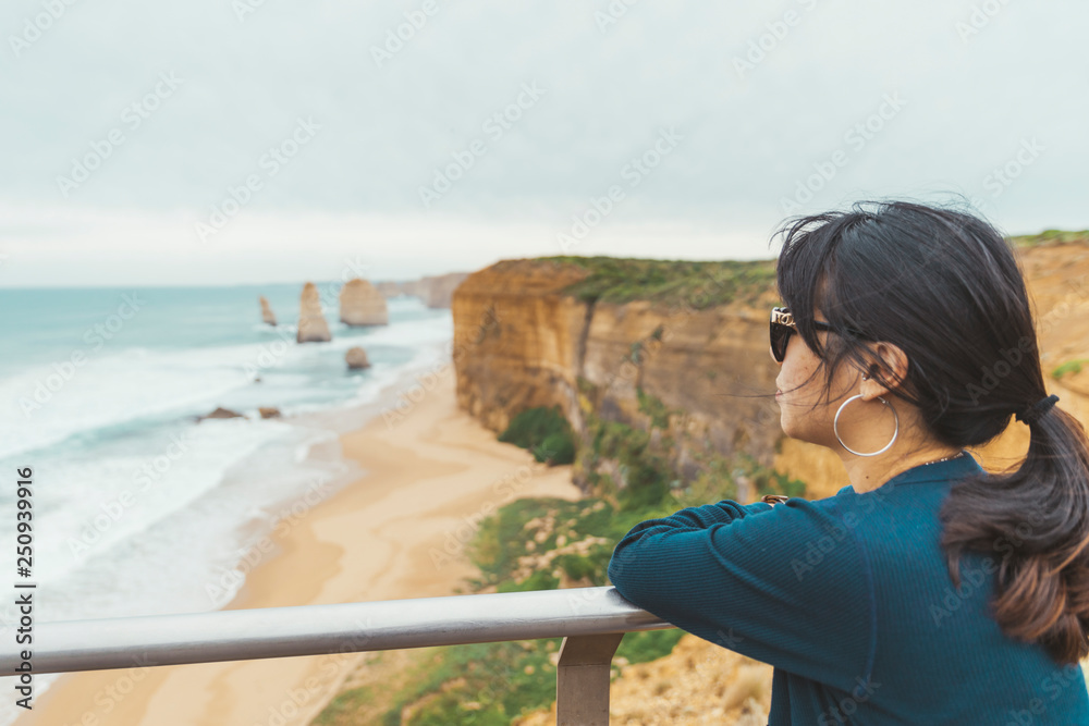 Asian woman visit the Twelve Apostles. The most popular place for tourist in Victoria, Australia.