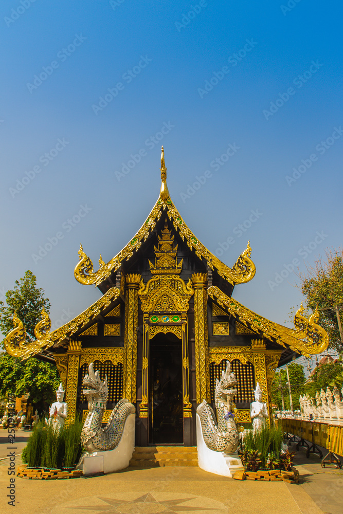 Beautiful golden Buddhist church in Lanna style architecture at Wat Inthakin Sadue Muang, Chiang Mai, Thailand. Wat Inthakin is the Buddhist temple where the Chiang Mai city pillar was placed in 1296.