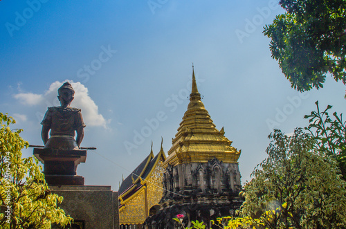 Old elephant chedi with golden top pagoda at Wat Chiang Man or Wat Chiang Mun, the oldest temple in Chiang Mai, Thailand, built in 1296 by King Mengrai in Lanna-style with elephant-shaped buttresses. photo