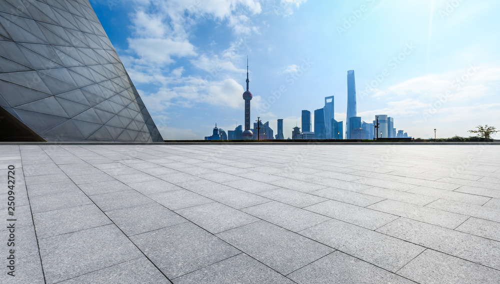 Empty square floor and backlit city skyline in Shanghai,China