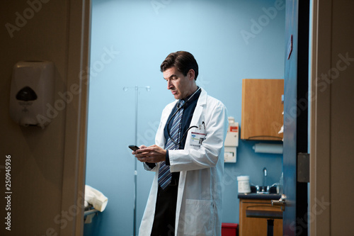 Doctor texting on mobile phone 