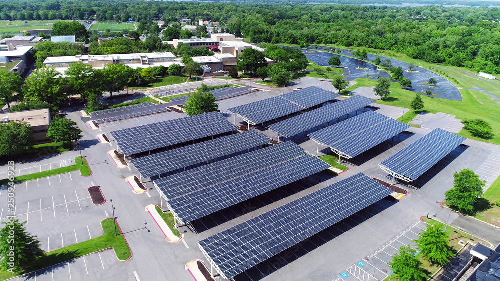 aerial view of solar panels installed in parking - obrazy, fototapety, plakaty 