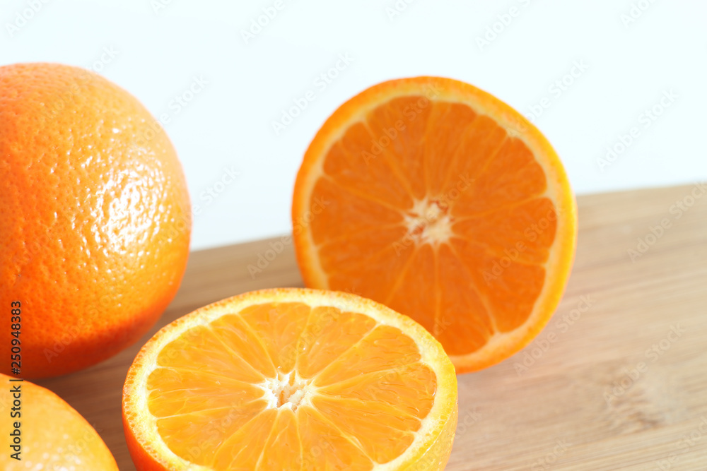 Fresh Oranges on a Wooden board. White background. Fresh Oranges on a Wooden board. White background.