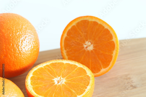 Fresh Oranges on a Wooden board. White background.