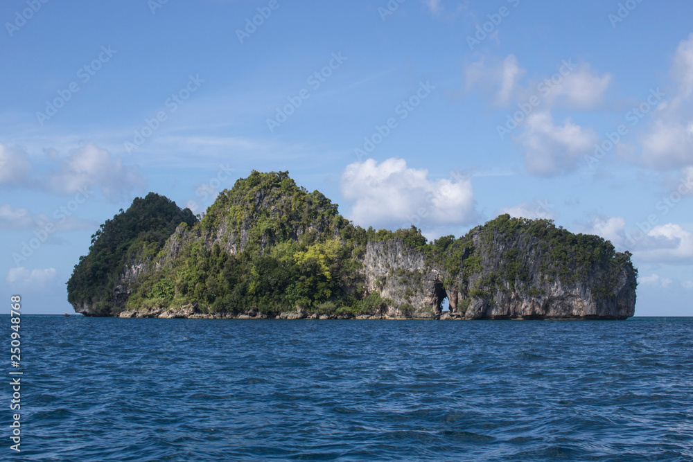 Rock Island with Arch Rises from Pacific in Micronesia