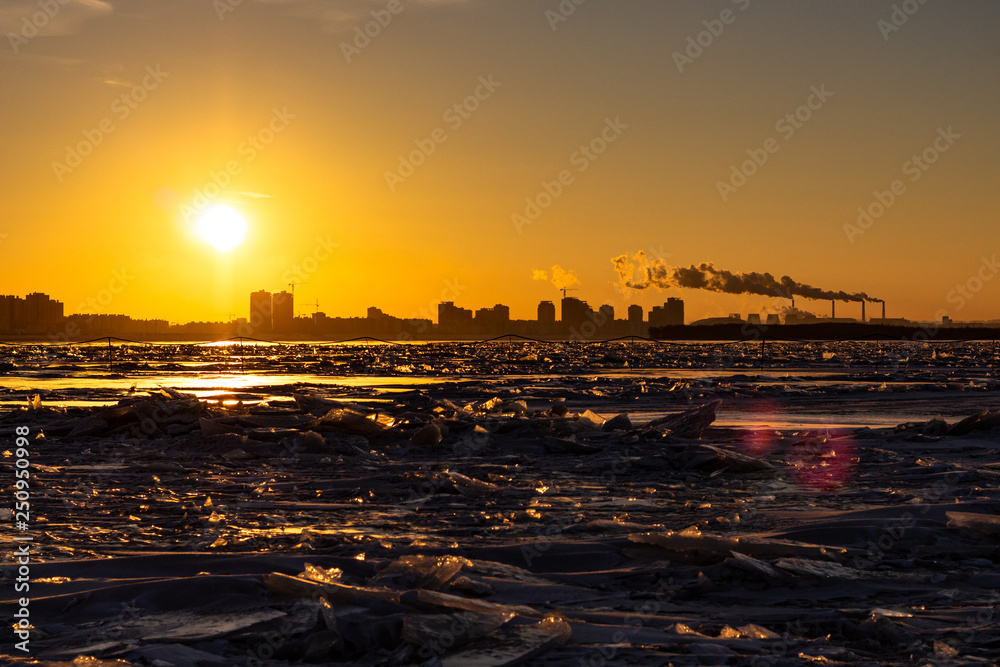 View of the city of Khabarovsk from the Amur river at dawn. Frozen river. The industrial look.