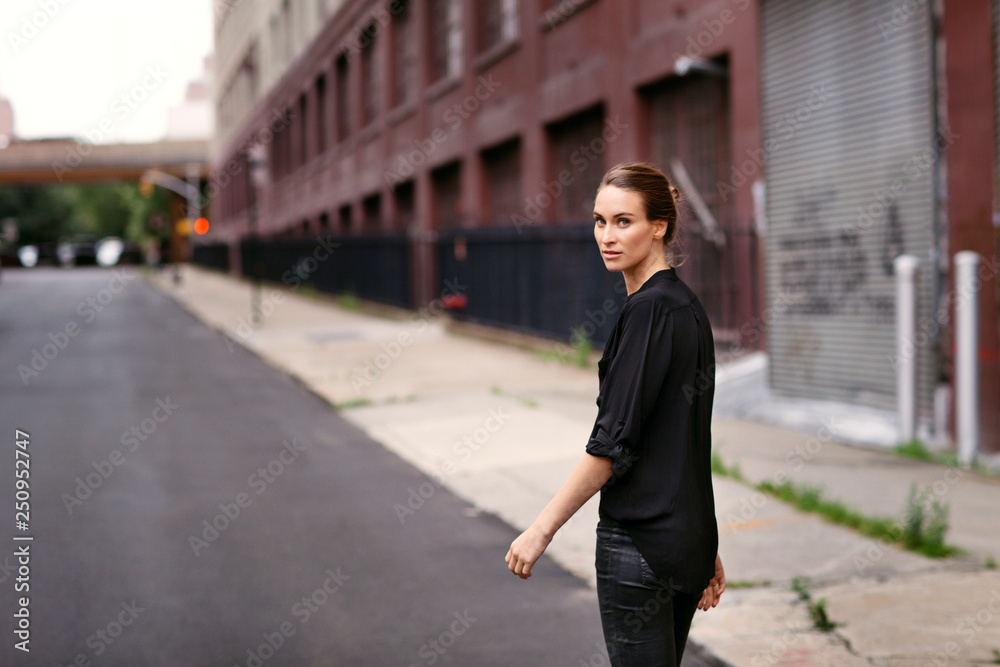 Portrait of young woman walking on street Portrait of young woman walking on street