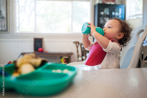 Baby girl (12-17 months) drinking from bottle 