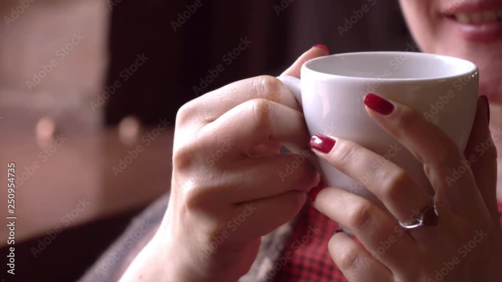 Woman using app on smartphone in cafe drinking coffee smiling and texting on mobile phone. Beautiful multicultural young casual female professional on mobile phone. Mixed race Asian Caucasian model. Woman using app on smartphone in cafe drinking coffee smiling and texting on mobile phone. Beautiful multicultural young casual female professional on mobile phone. Mixed race Asian Caucasian model.