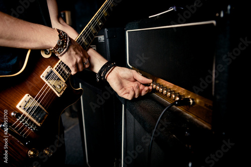 Hand turning dials on guitar amplifier  photo