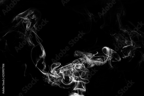 Smoke the white incense on a black background. darkness concept