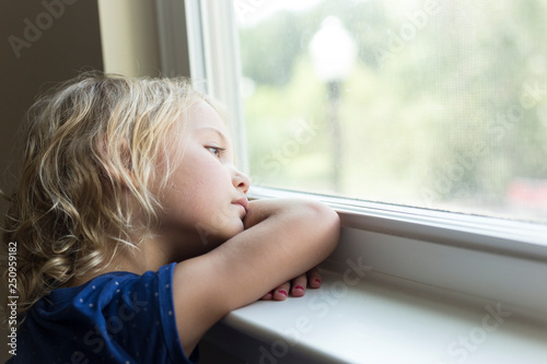 Little girl looking out the window
