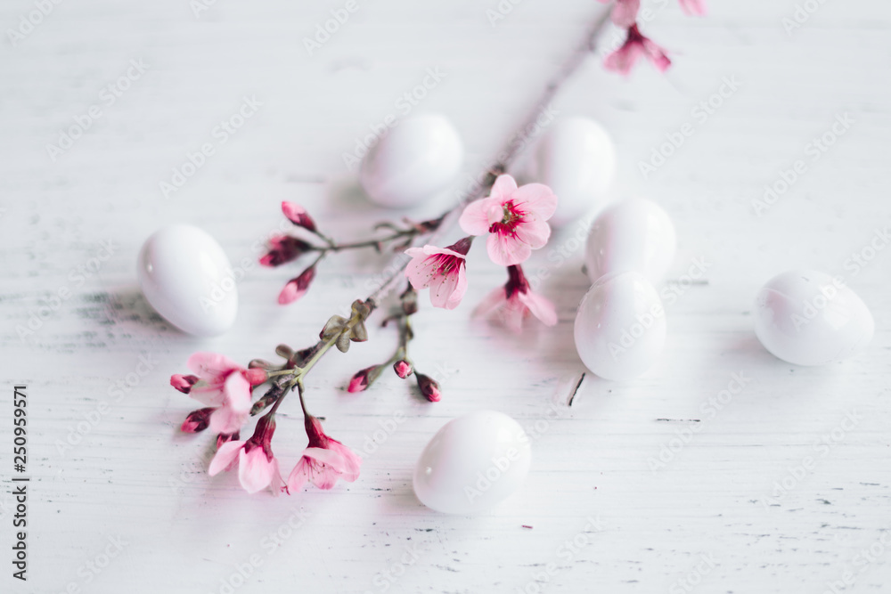 Spring blossom pink flowers In the glass And white eggs
