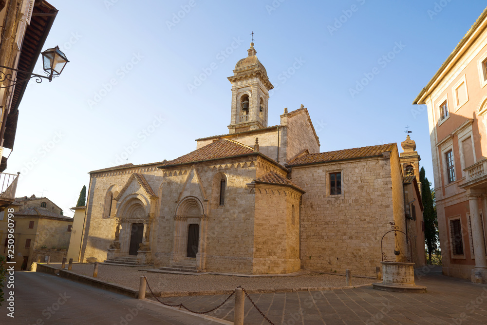 The medieval church of La Collegiata dei Santi Quirico e Juliette in the town of San Quirico d'Orcia on September evening. Italy