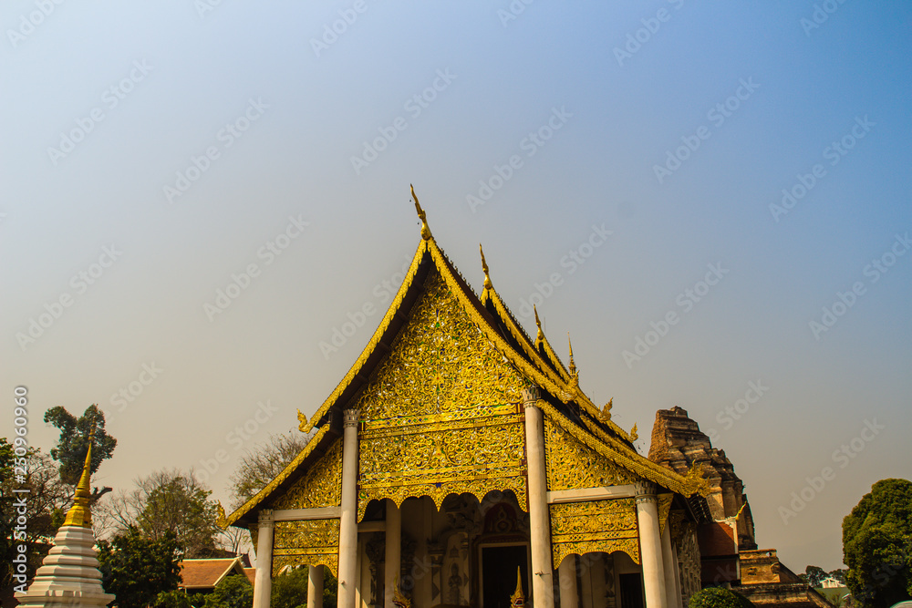 Lanna's style golden patterned background on the Buddhist church gable end. Thai golden pattern background crafted on the gable in the Buddhist temple with Lanna style at Wat Chedi Luang, Chiang Mai. Lanna's style golden patterned background on the Buddhist church gable end. Thai golden pattern background crafted on the gable in the Buddhist temple with Lanna style at Wat Chedi Luang, Chiang Mai.