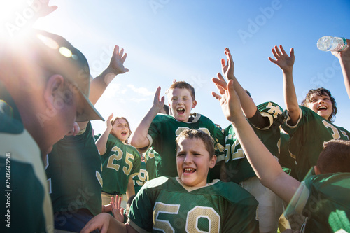Boys (10-11) greeting before american football match 