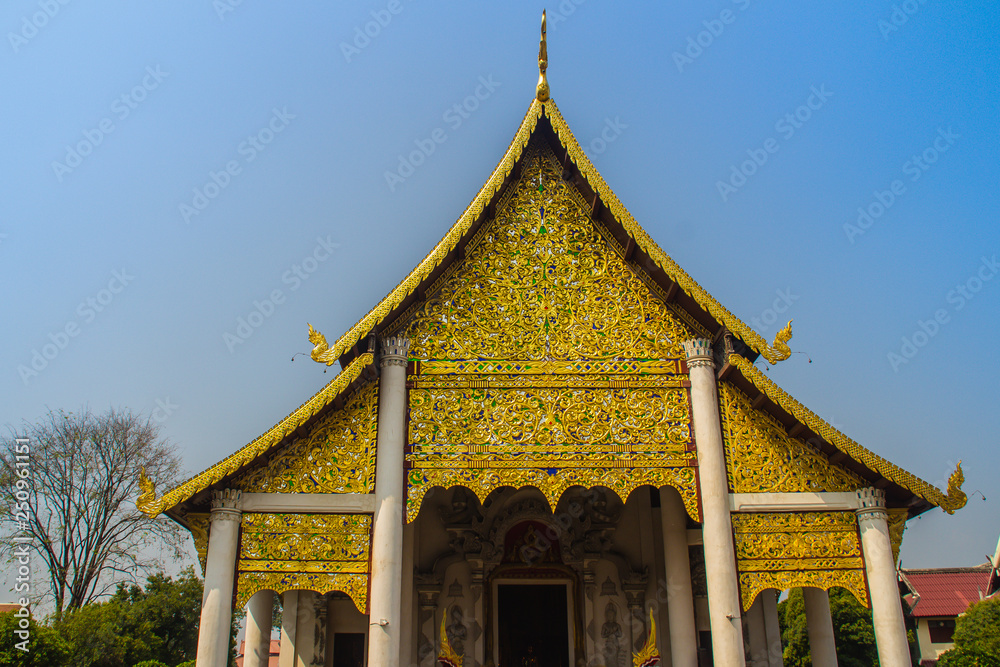 Lanna's style golden patterned background on the Buddhist church gable end. Thai golden pattern background crafted on the gable in the Buddhist temple with Lanna style at Wat Chedi Luang, Chiang Mai.