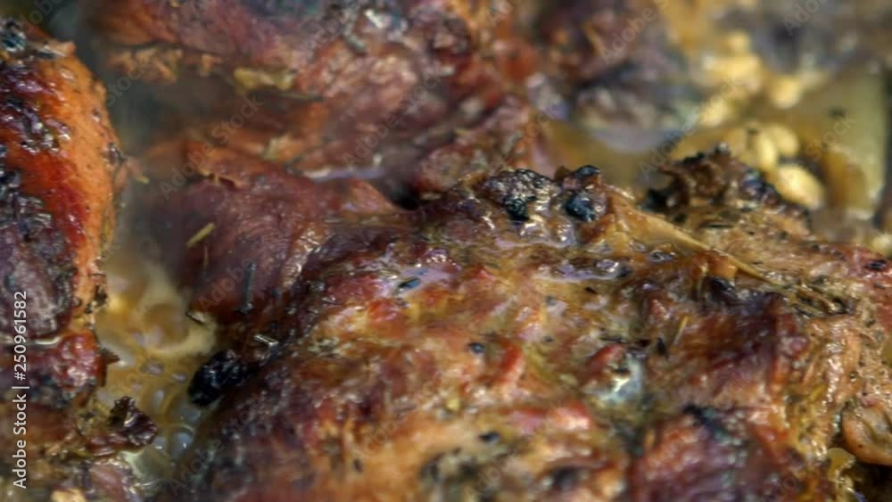 Slow Motion of chef cooking pork being grilled on barbecue. Very delicious roast pig meat on a BBQ grill in backyard. Food cooked with grilling BBQ in the garden of a house-Dan Slow Motion of chef cooking pork being grilled on barbecue. Very delicious roast pig meat on a BBQ grill in backyard. Food cooked with grilling BBQ in the garden of a house-Dan